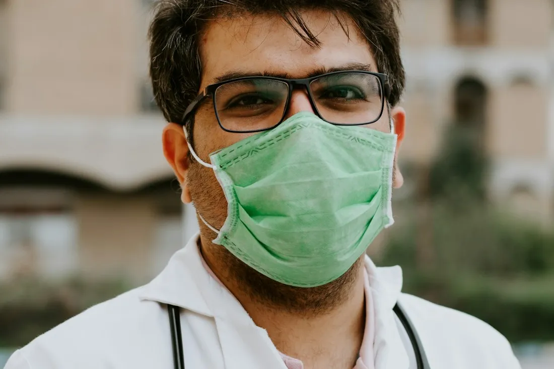 Healthcare professional welcoming a client into a clean clinic room